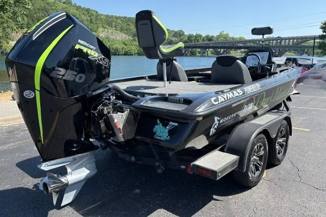 Slide: The Image of 2023 Caymas CX 20 PRO boat with Mercury engine, parked near a scenic river. - 3