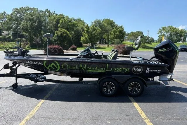 Slide: The Image of 2023 Caymas CX 20 PRO boat with Ozark Mountain Logging branding in a parking lot. - 7
