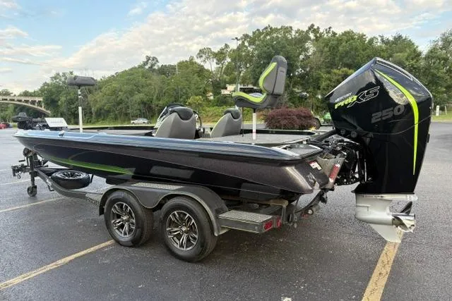 Slide: The Image of 2023 Caymas CX 20 PRO boat with powerful engine, parked on a trailer in a scenic area. - 14