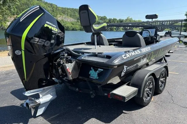 Slide: The Image of 2023 Caymas CX 20 PRO boat with powerful Mercury engine, parked near a scenic river. - 5