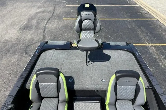 Slide: The Image of 2023 Caymas CX 20 PRO boat interior with gray and green seating, parked on asphalt. - 32