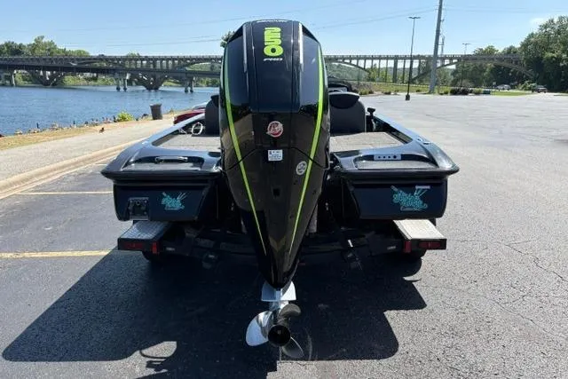 Slide: The Image of 2023 Caymas CX 20 PRO boat with powerful outboard motor, parked near a scenic river. - 9