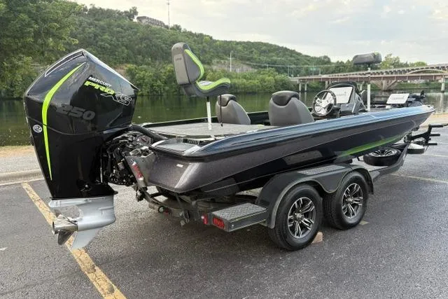 Slide: The Image of 2023 Caymas CX 20 PRO boat with powerful engine, parked near a scenic river. - 5