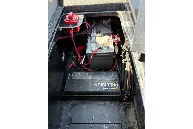 Slide: The Image of 2023 Caymas CX 20 PRO boat battery compartment with wiring and precision charger. - 26