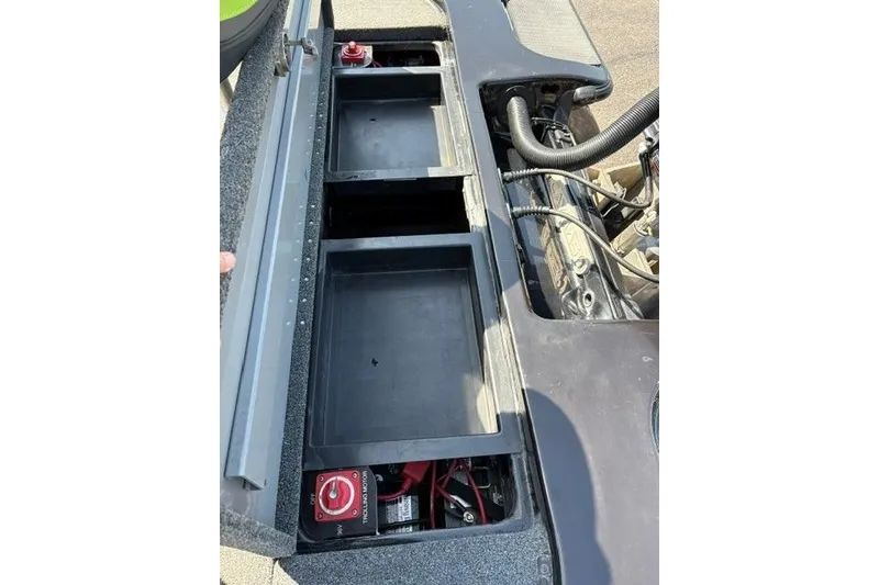 Slide: The Image of 2023 Caymas CX 20 PRO boat battery compartment with storage trays and wiring. - 48