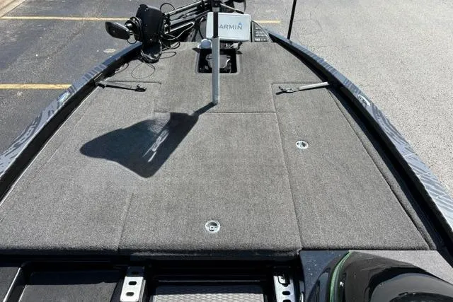Slide: The Image of 2023 Caymas CX 20 PRO boat deck with Garmin equipment, featuring a spacious, carpeted layout. - 18