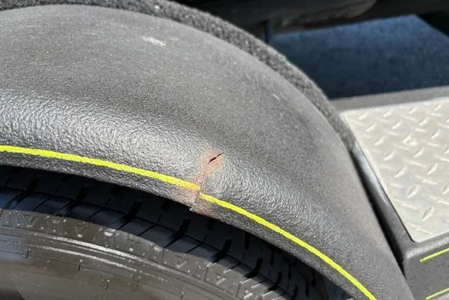 Slide: The Image of Close-up of a 2023 Caymas CX 20 PRO trailer fender with a visible crack. - 49