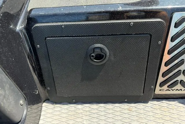 Slide: The Image of 2023 Caymas CX 20 PRO boat compartment with textured black panel and latch. - 23
