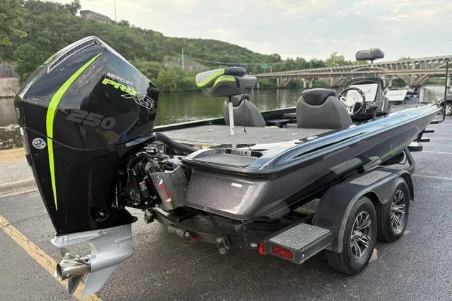 Slide: The Image of 2023 Caymas CX 20 PRO boat with Mercury 250 engine, parked near a river. - 9