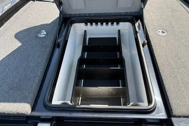 Slide: The Image of 2023 Caymas CX 20 PRO boat storage compartment with open lid and organized interior. - 12