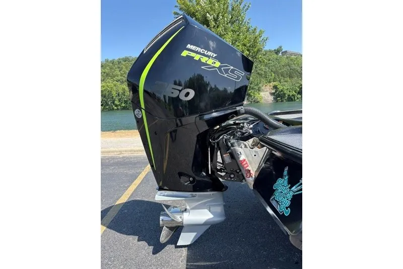 Slide: The Image of 2023 Caymas CX 20 PRO with Mercury Pro XS 250 engine, parked by a scenic lake. - 10
