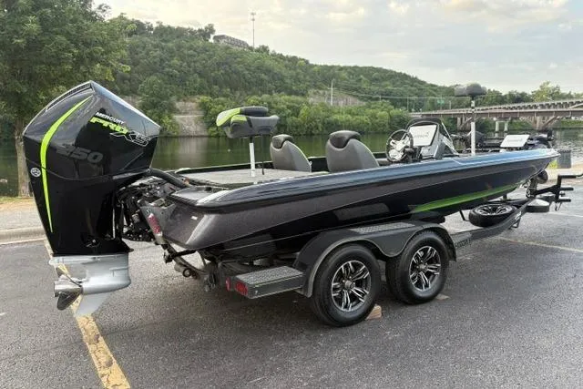 Slide: The Image of 2023 Caymas CX 20 PRO boat on trailer by a scenic riverside. - 11