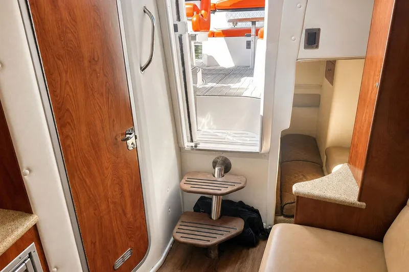 Slide: The Image of Interior view of 2012 Rinker 310 Express Cruiser LE, featuring wooden door and steps. - 51