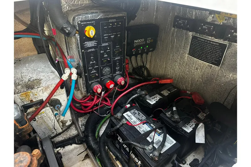 Slide: The Image of Electrical system of a 2012 Rinker 310 Express Cruiser LE with batteries and wiring. - 54
