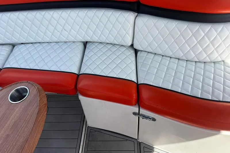 Slide: The Image of Luxurious seating on 2012 Rinker 310 Express Cruiser LE with quilted upholstery and wooden table. - 20