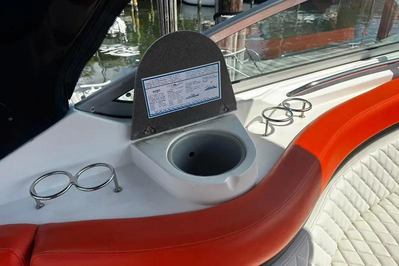 Slide: The Image of Interior of 2012 Rinker 310 Express Cruiser LE with cup holders and seating. - 23