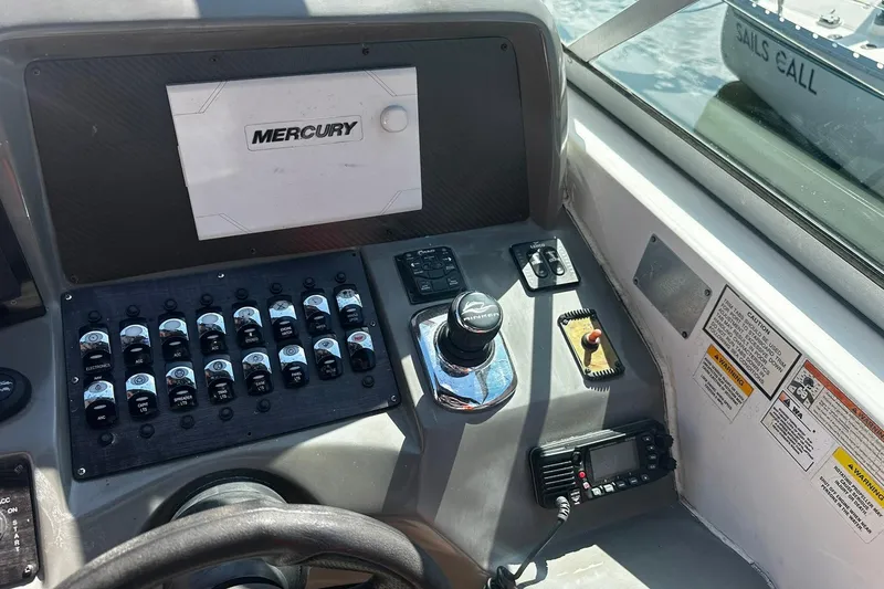 Slide: The Image of Control panel of a 2012 Rinker 310 Express Cruiser LE boat. - 27