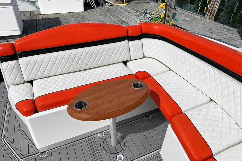 Slide: The Image of Luxurious seating on 2012 Rinker 310 Express Cruiser LE with red and white upholstery. - 17