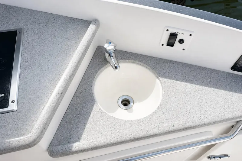 Slide: The Image of 2012 Rinker 310 Express Cruiser LE boat sink and countertop detail. - 15