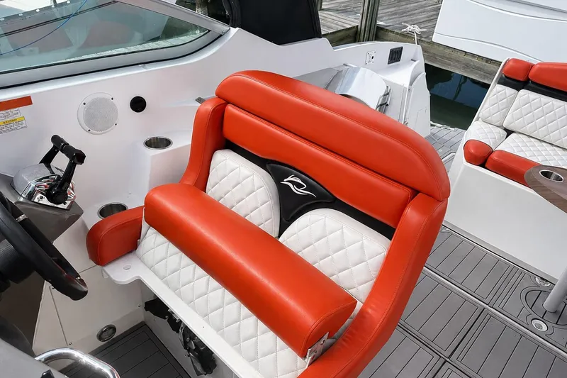 Slide: The Image of 2012 Rinker 310 Express Cruiser LE interior with red and white seating, modern design. - 29