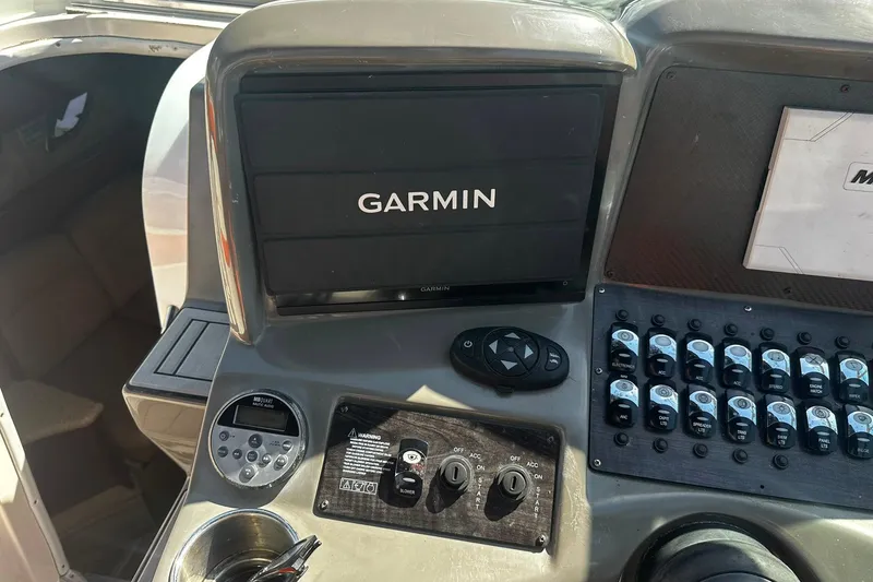 Slide: The Image of Control panel of a 2012 Rinker 310 Express Cruiser LE with Garmin display. - 26