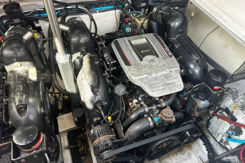 Slide: The Image of Engine compartment of a 2012 Rinker 310 Express Cruiser LE boat. - 56
