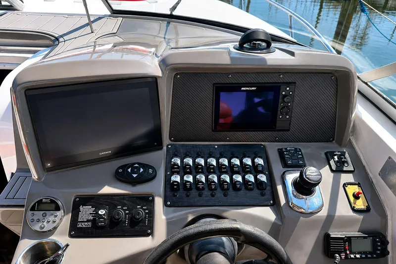 Slide: The Image of Control panel of 2012 Rinker 310 Express Cruiser LE with Garmin and Mercury displays. - 28