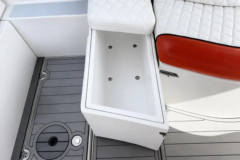 Slide: The Image of 2012 Rinker 310 Express Cruiser LE interior with open storage compartment and cushioned seating. - 21