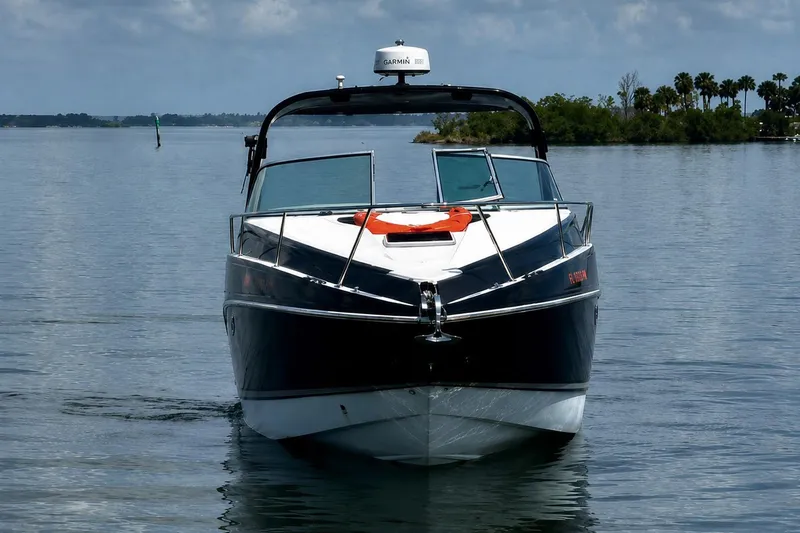 Slide: The Image of 2012 Rinker 310 Express Cruiser LE on calm water, front view. - 4