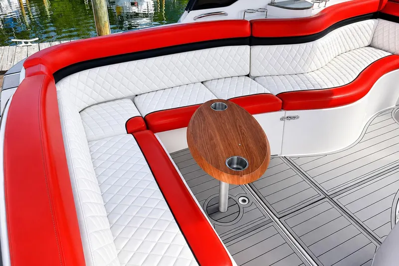 Slide: The Image of Luxurious seating on 2012 Rinker 310 Express Cruiser LE with red and white upholstery. - 13