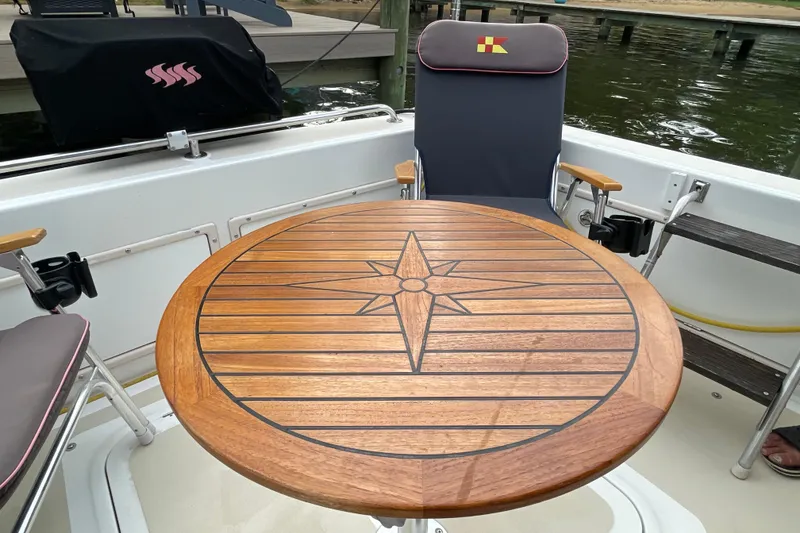 Slide: The Image of Wooden table with compass design on Fox Island Thirty Sedan Cruiser, 2005 model. - 10