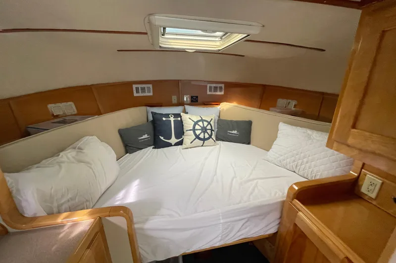 Slide: The Image of Cozy cabin interior of 2005 Fox Island Thirty Sedan Cruiser with nautical-themed pillows. - 32