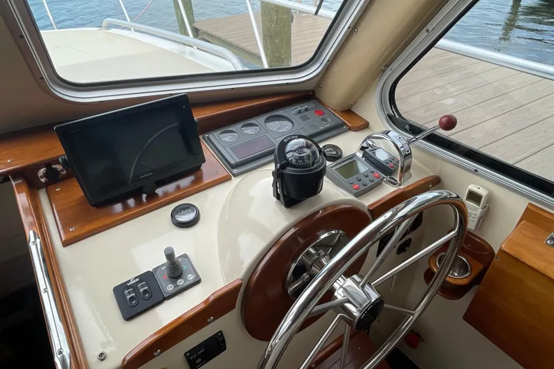Slide: The Image of Helm of 2005 Fox Island Thirty Sedan Cruiser with navigation equipment and steering wheel. - 12