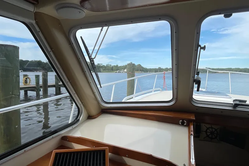 Slide: The Image of Interior view from a 2005 Fox Island Thirty Sedan Cruiser, overlooking a serene waterfront. - 36