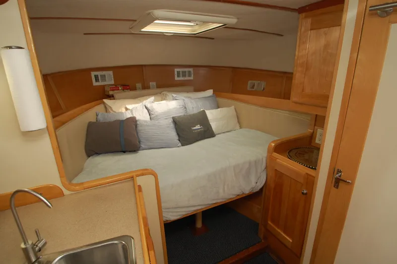 Slide: The Image of Interior of a 2005 Fox Island Thirty - Sedan Cruiser with cozy bed and wood paneling. - 18