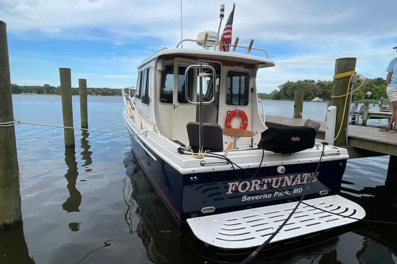 Slide: The Image of 2005 Fox Island Thirty Sedan Cruiser docked, displaying "Fortunate" and Severna Park, MD. - 2