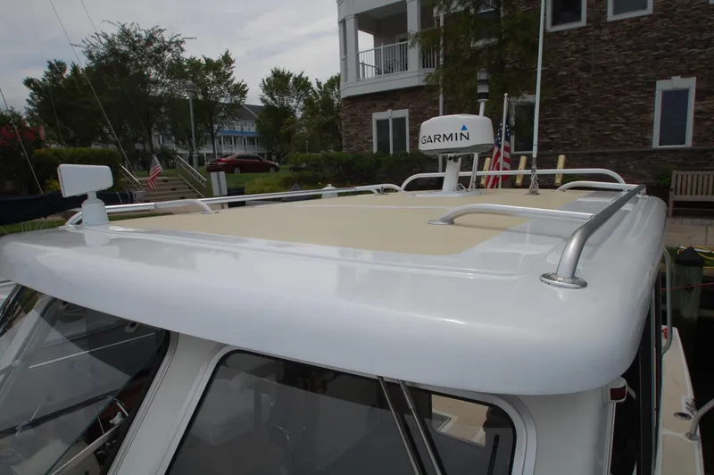 Slide: The Image of The image shows the roof of a 2005 Fox Island Thirty - Sedan Cruiser with railing and Garmin antenna. - 24