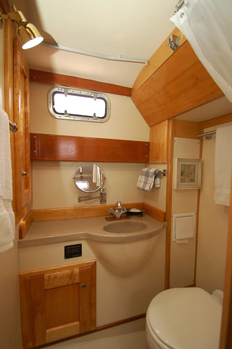 Slide: The Image of The image shows a bathroom with wood paneling, a sink, and a small window. - 20
