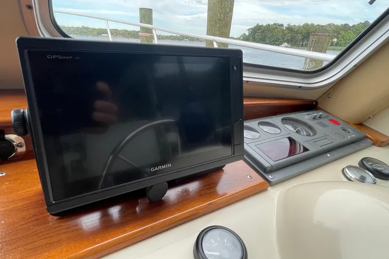 Slide: The Image of Garmin GPS system on 2005 Fox Island Thirty Sedan Cruiser dashboard, overlooking water. - 11