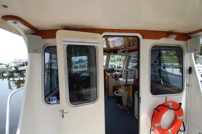Slide: The Image of Interior view of a 2005 Fox Island Thirty - Sedan Cruiser with open door and life ring. - 25