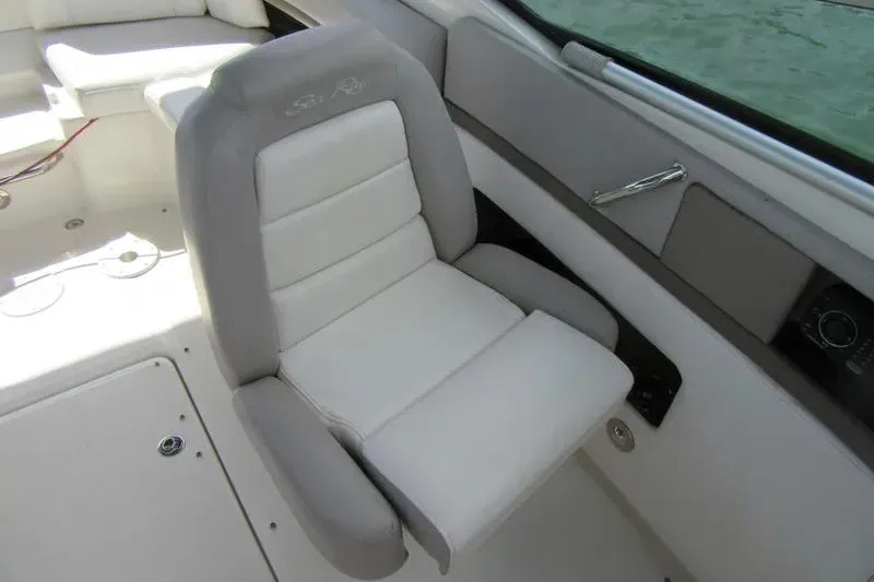Slide: The Image of 2011 Sea Ray SLX 250 boat interior with a comfortable white captain's chair. - 23