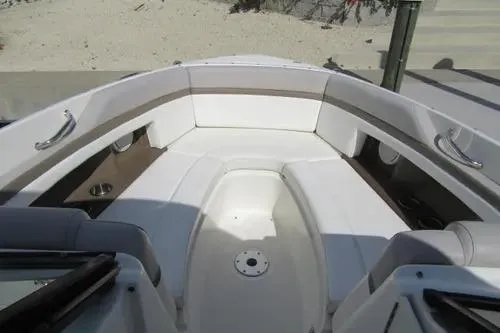 Slide: The Image of 2011 Sea Ray SLX 250 boat interior with white seating and cup holders. - 12