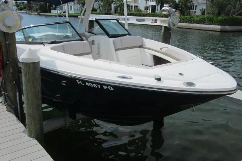 Slide: The Image of 2011 Sea Ray SLX 250 boat docked in a marina, featuring sleek design and spacious seating. - 5