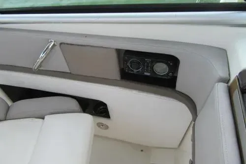 Slide: The Image of 2011 Sea Ray SLX 250 boat interior with control panel and seating. - 26