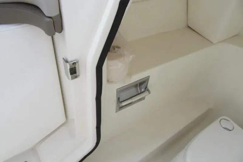 Slide: The Image of Interior view of a 2011 Sea Ray SLX 250 boat, featuring a white cabin area. - 30