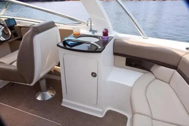 Slide: The Image of Interior of 2011 Sea Ray SLX 250 boat with seating and refreshments on a sunny day. - 25