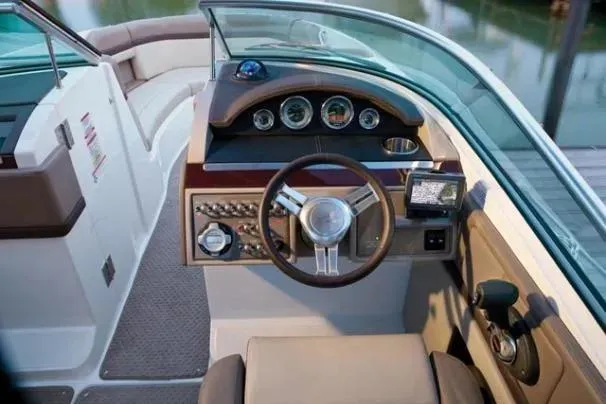 Slide: The Image of 2011 Sea Ray SLX 250 boat cockpit with steering wheel and control panel. - 21