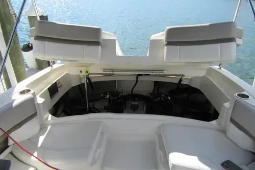 Slide: The Image of 2011 Sea Ray SLX 250 boat interior with open engine compartment, docked by the water. - 11