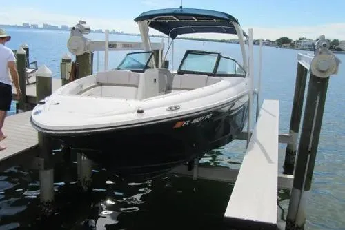 Slide: The Image of 2011 Sea Ray SLX 250 boat docked on a lift by the water. - 3