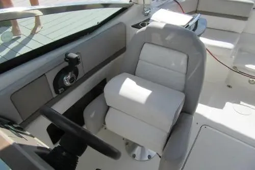Slide: The Image of 2011 Sea Ray SLX 250 boat interior with steering wheel and seating. - 22